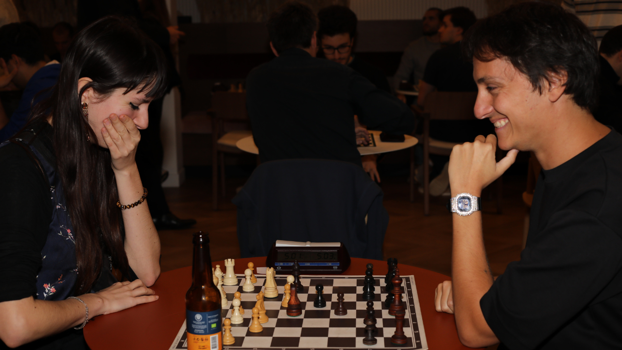 Two players facing each other over a chessboard