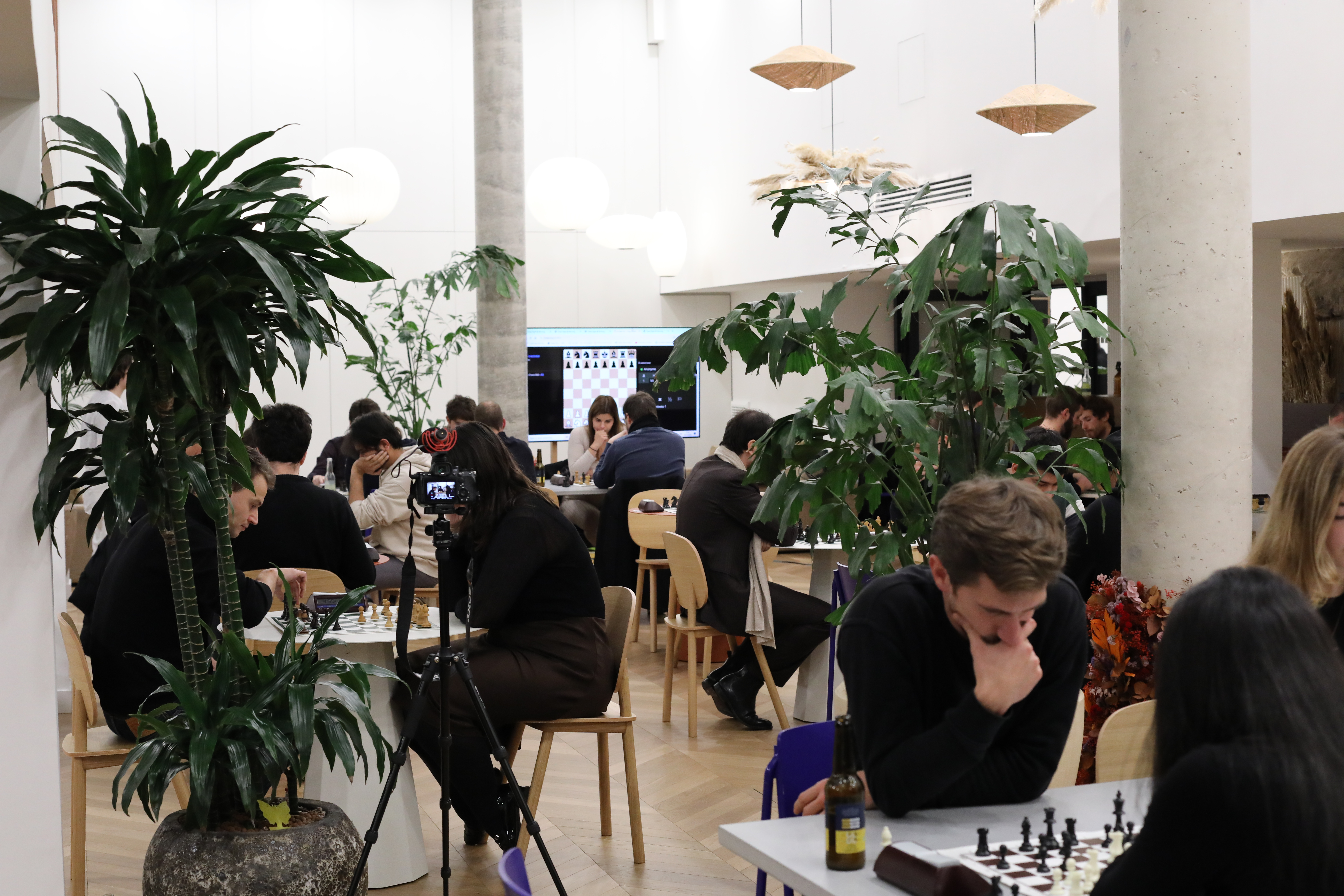 Players enjoying chess among the plants at Morning Trévise